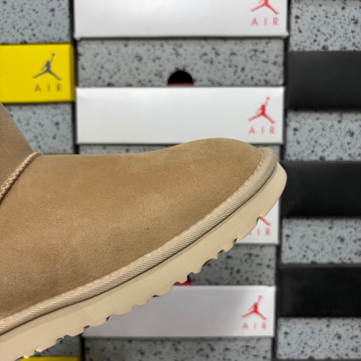 UGG Mini Bailey Bow Ankle Boot – Suede Boot with Cream Shearling Lining, Satin Bow Detail & Sand Sugar Sole in Sand